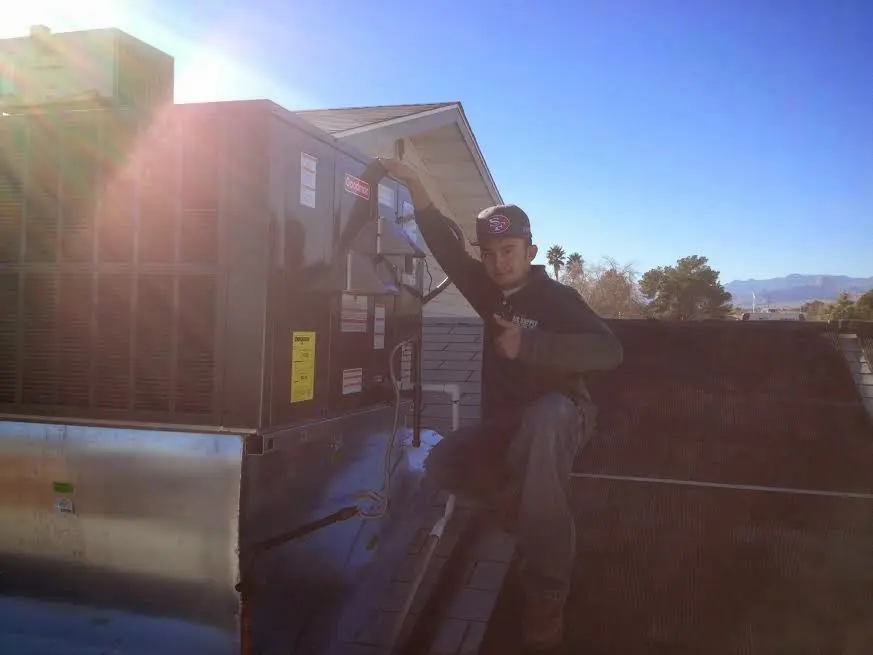 HVAC technician performing HVAC Inspection on a rooftop unit in Willmar